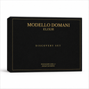 A black rectangular product box with elegant gold lettering reading 'MODELLO DOMANI ELIXIR' and 'DISCOVERY SET' on a clean white background.