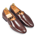Pair of brown leather loafers with wooden insoles on a white background