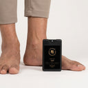 Person wearing beige pants with a black device on a white background. shoe care, skin friendly shoe sanitizer. shoe health.